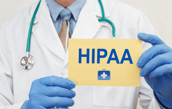 Doctor holding a HIPAA compliance placard, symbolizing adherence to healthcare privacy regulations.